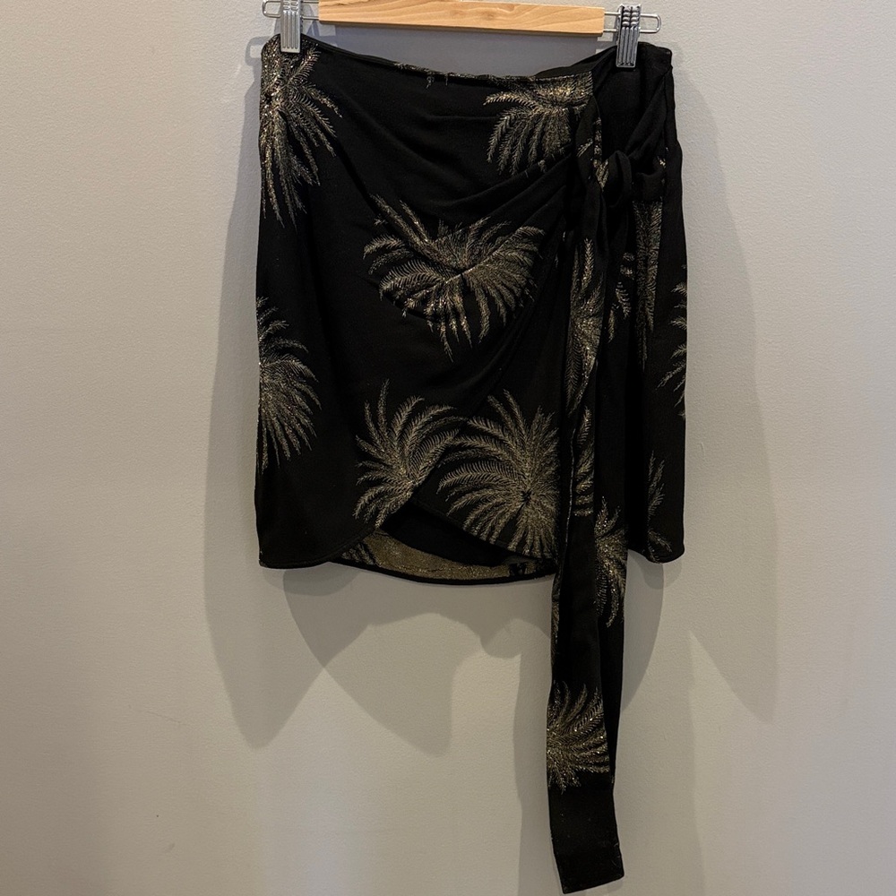 Victoria Beckham Black Mini skirt with tie and gold palms detail.